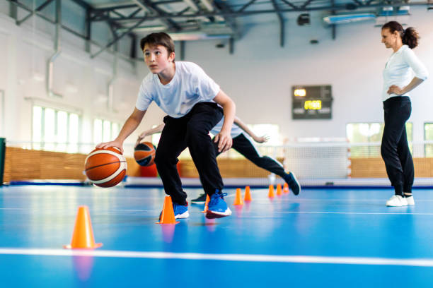 Student playing basketball in PE class, representing the value of daily physical education.